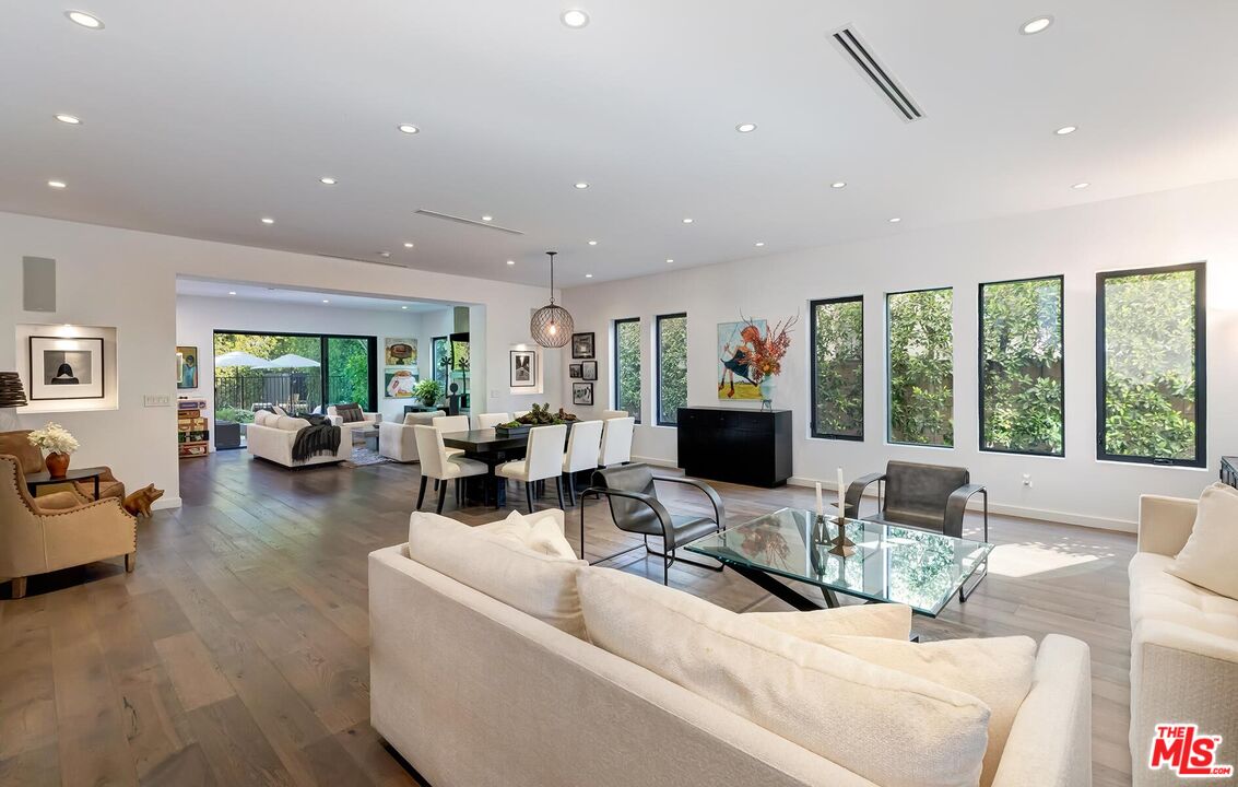 a living room with furniture and large windows