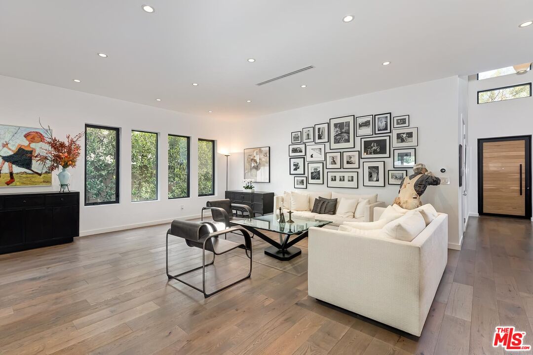 10521 Northvale Road Los Angeles, CA 90064 - Photo 12 of 52 a living room with furniture floor to ceiling window and flat screen tv