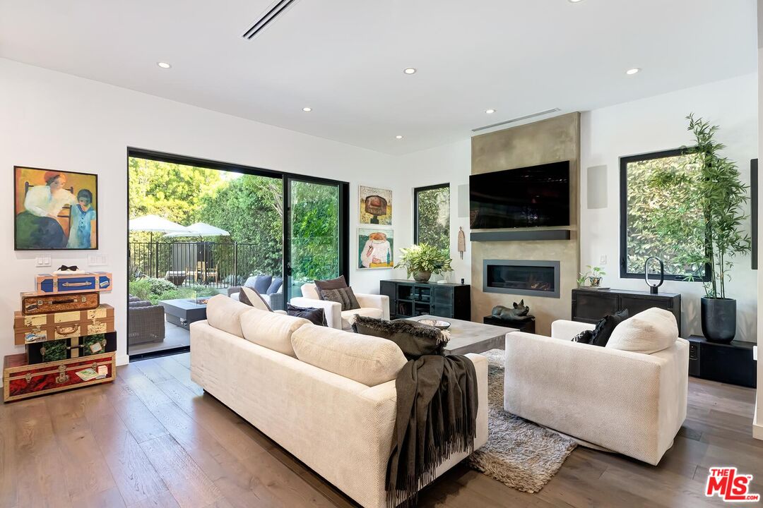10521 Northvale Road Los Angeles, CA 90064 - Photo 19 of 52 a living room with furniture a fireplace and a flat screen tv