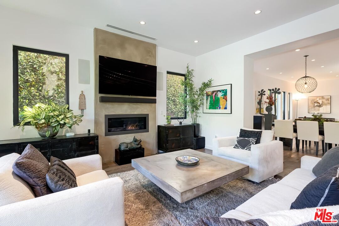 10521 Northvale Road Los Angeles, CA 90064 - Photo 20 of 52 a living room with furniture a flat screen tv and a fireplace
