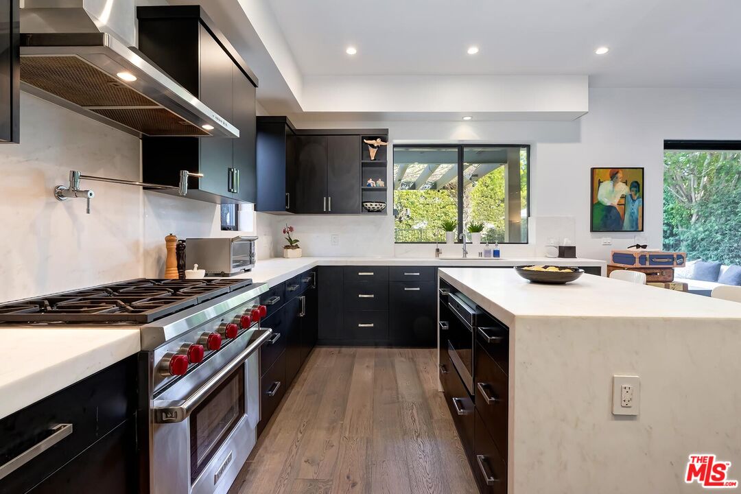 10521 Northvale Road Los Angeles, CA 90064 - Photo 25 of 52 a kitchen with stainless steel appliances granite countertop a stove a sink and a refrigerator