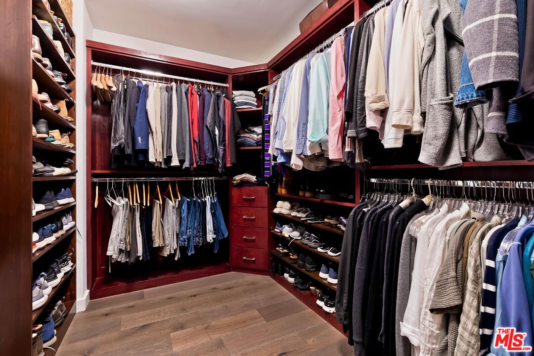 10521 Northvale Road Los Angeles, CA 90064 - Photo 34 of 52 a view of walk in closet with clothes and shoes