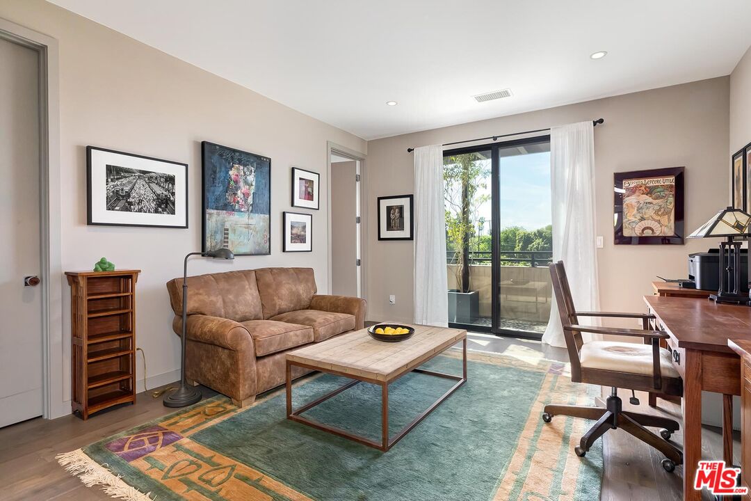 10521 Northvale Road Los Angeles, CA 90064 - Photo 40 of 52 a living room with furniture a wooden floor and next to a window
