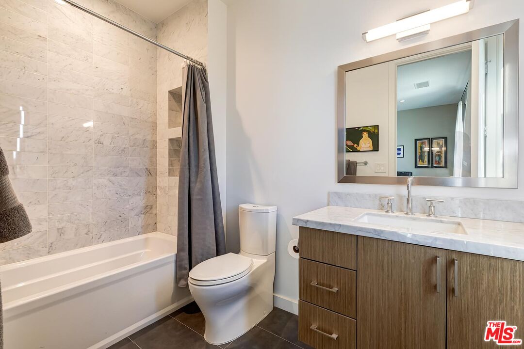 10521 Northvale Road Los Angeles, CA 90064 - Photo 42 of 52 a bathroom with a granite countertop sink toilet and shower