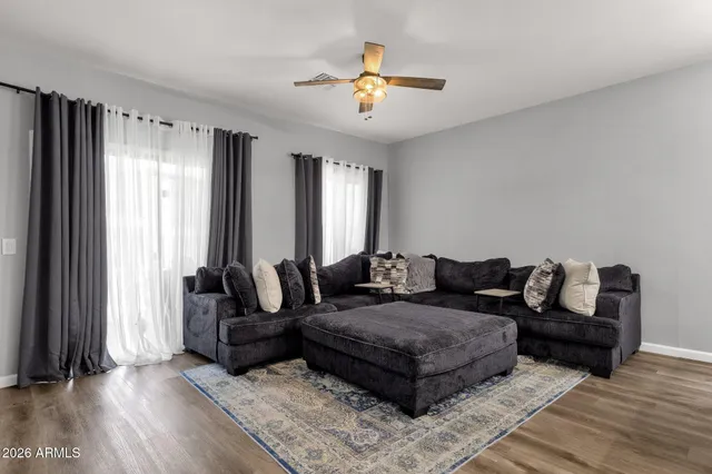 a living room with furniture and a large window