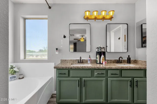 a bathroom with a granite countertop sink a toilet and mirror