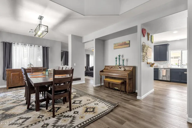 a dining room with wooden floor and breakfast area