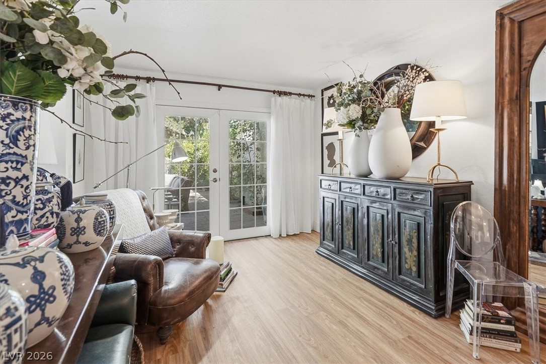 6250 West Flamingo Road, Unit 93 Las Vegas, NV 89103 - Photo 17 of 38 Bright, airy living space features classic french doors and warm hardwood flooring.