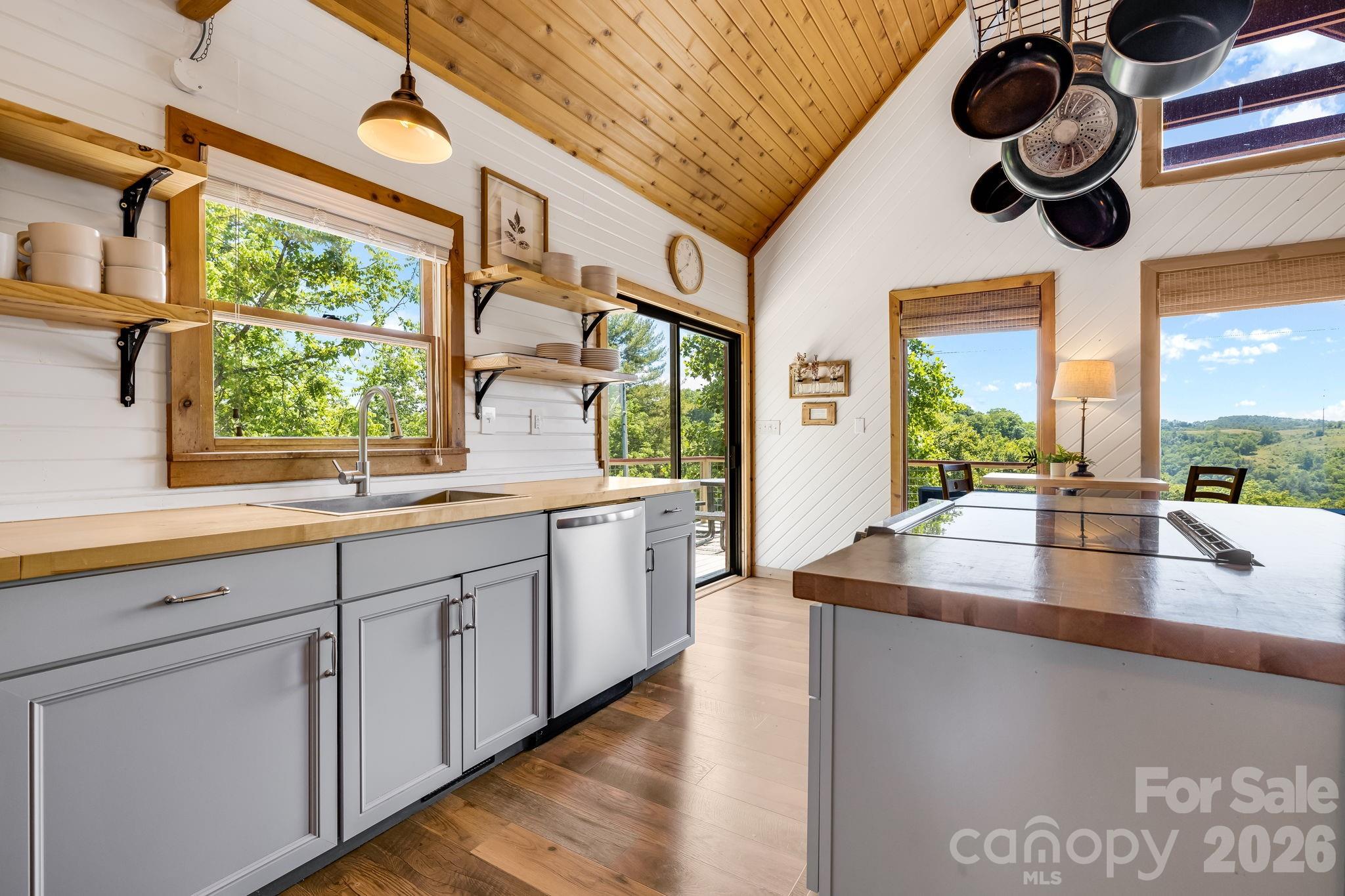 694 Boulder Road Marshall, NC 28753 - Photo 14 of 44 a large kitchen with a large window and stainless steel appliances