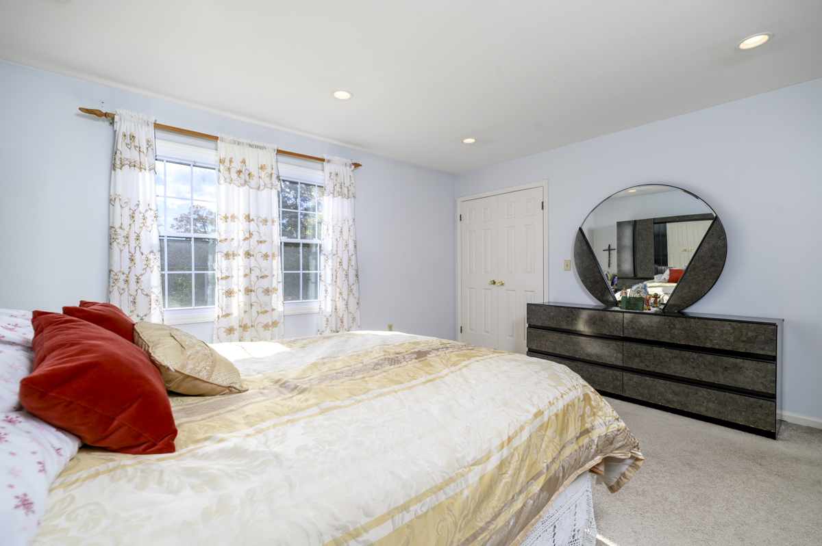 209 Seaside Avenue, Unit 2 Stamford, CT 06902 - Photo 12 of 19 a bedroom with a bed a mirror and dresser
