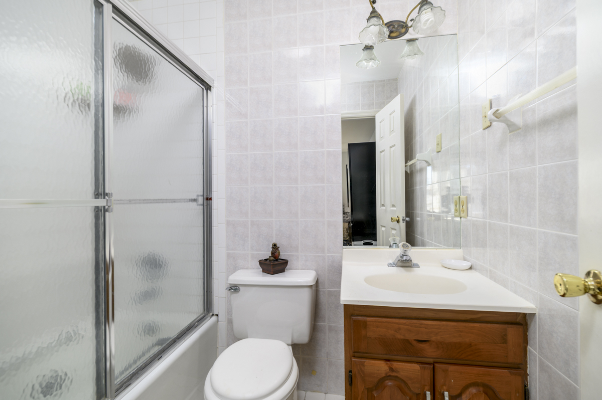 209 Seaside Avenue, Unit 2 Stamford, CT 06902 - Photo 13 of 19 a bathroom with a sink toilet and shower