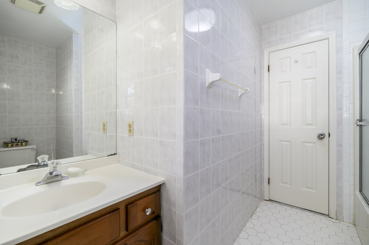 209 Seaside Avenue, Unit 2 Stamford, CT 06902 - Photo 14 of 19 a bathroom with a sink shower and a mirror
