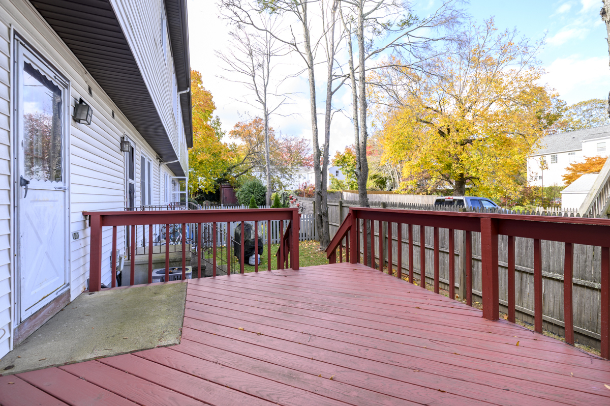 209 Seaside Avenue, Unit 2 Stamford, CT 06902 - Photo 17 of 19 a balcony with wooden floor and fence