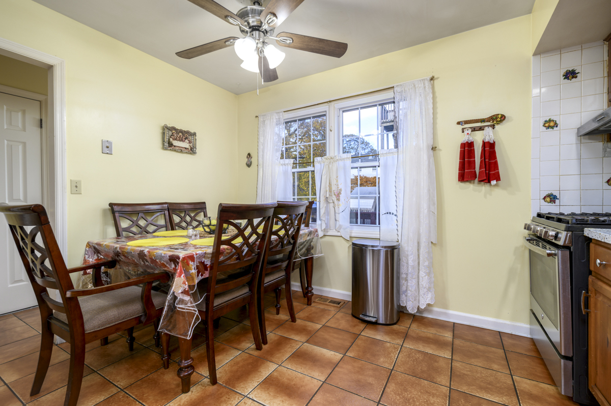 209 Seaside Avenue, Unit 2 Stamford, CT 06902 - Photo 7 of 19 a view of a dining room with furniture and a chandelier
