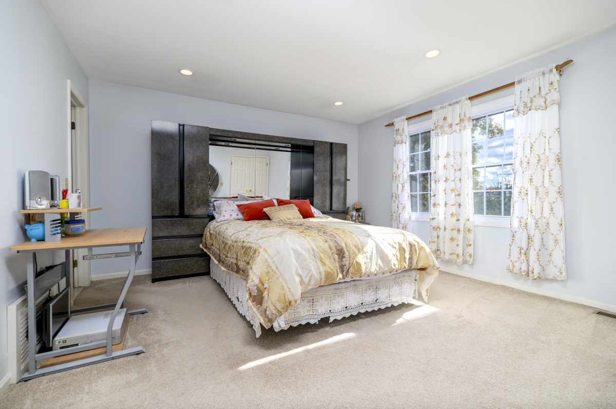 209 Seaside Avenue, Unit 2 Stamford, CT 06902 - Photo 10 of 19 a bed sitting in a bedroom next to a window