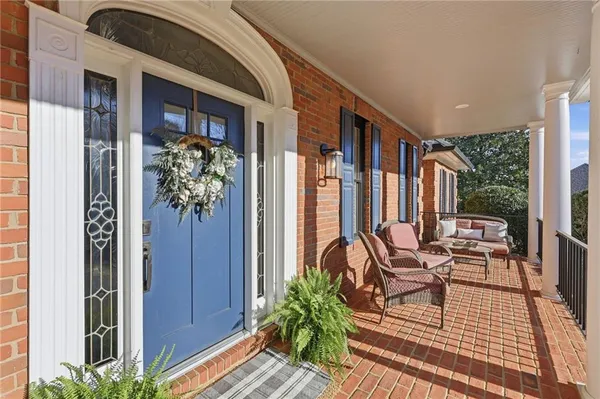 a kitchen with stainless steel appliances a table and chairs in it