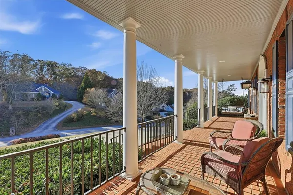 a dining room with furniture a chandelier and wooden floor