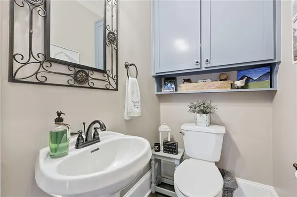 a kitchen with stainless steel appliances granite countertop a stove a sink dishwasher and a refrigerator with wooden floor