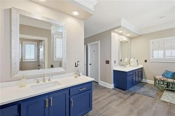 a spacious bedroom with a bed and a chandelier