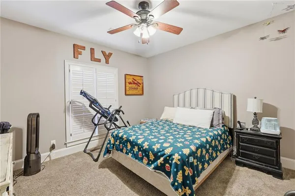 a spacious bedroom with a bed and a chandelier