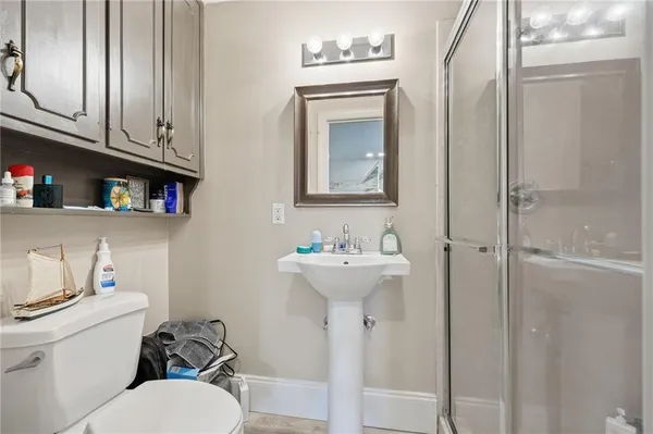 a spacious bedroom with two beds and a chandelier