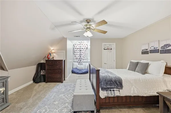 a kitchen with a stove a refrigerator and white cabinets with wooden floor