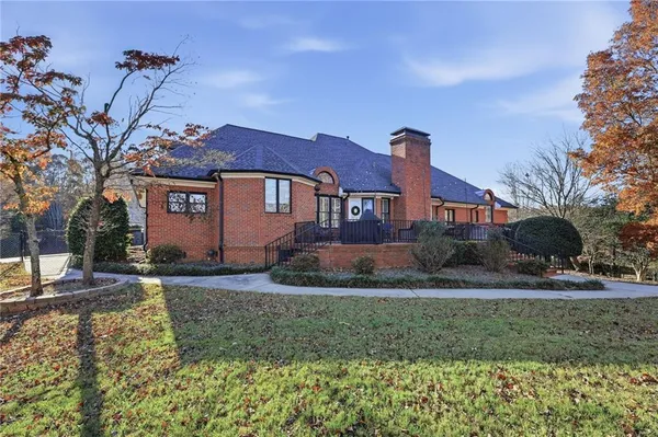a dining room with furniture a chandelier and wooden floor