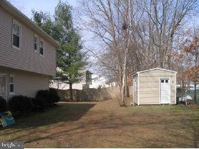 57 Woodland Road Bayville, NJ 08721 - Photo 2 of 6 a front view of a house with a yard and garage
