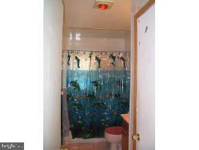 57 Woodland Road Bayville, NJ 08721 - Photo 3 of 6 a bathroom with a shower curtain
