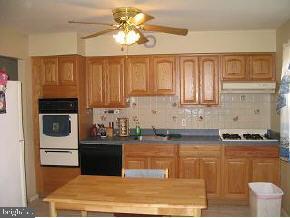 57 Woodland Road Bayville, NJ 08721 - Photo 5 of 6 a kitchen with stainless steel appliances granite countertop a stove a sink and a microwave