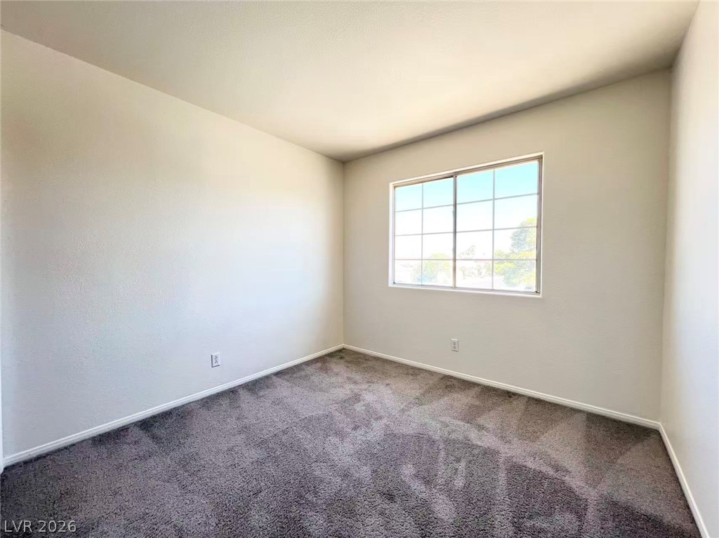 8284 West Rochelle Avenue Las Vegas, NV 89147 - Photo 25 of 29 A well-lit bedroom provides ample natural light and a neutral palette for personalized decor.