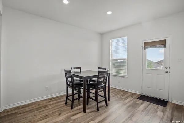 a view of a dining room with furniture and wooden floor