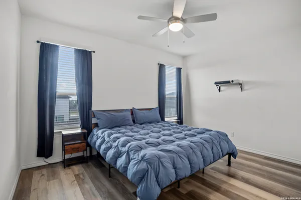 a bedroom with a bed and a ceiling fan