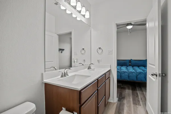 a bathroom with a sink a toilet and mirror
