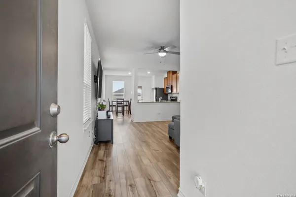 a view of a living room and bedroom with wooden floor