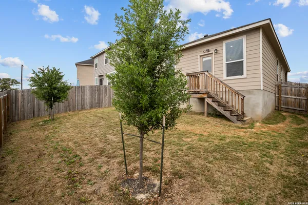 a house view with a backyard space