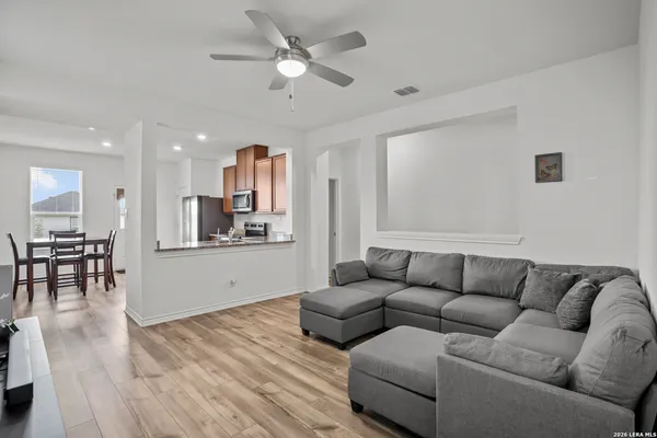 a living room with furniture and a wooden floor
