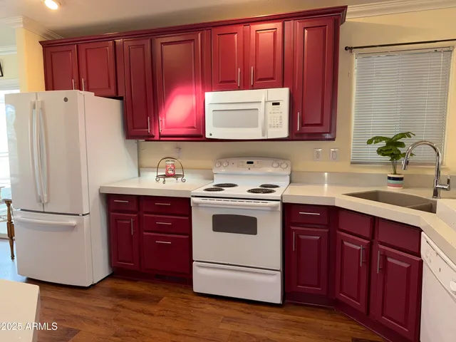 a kitchen with a sink cabinets and wooden floor
