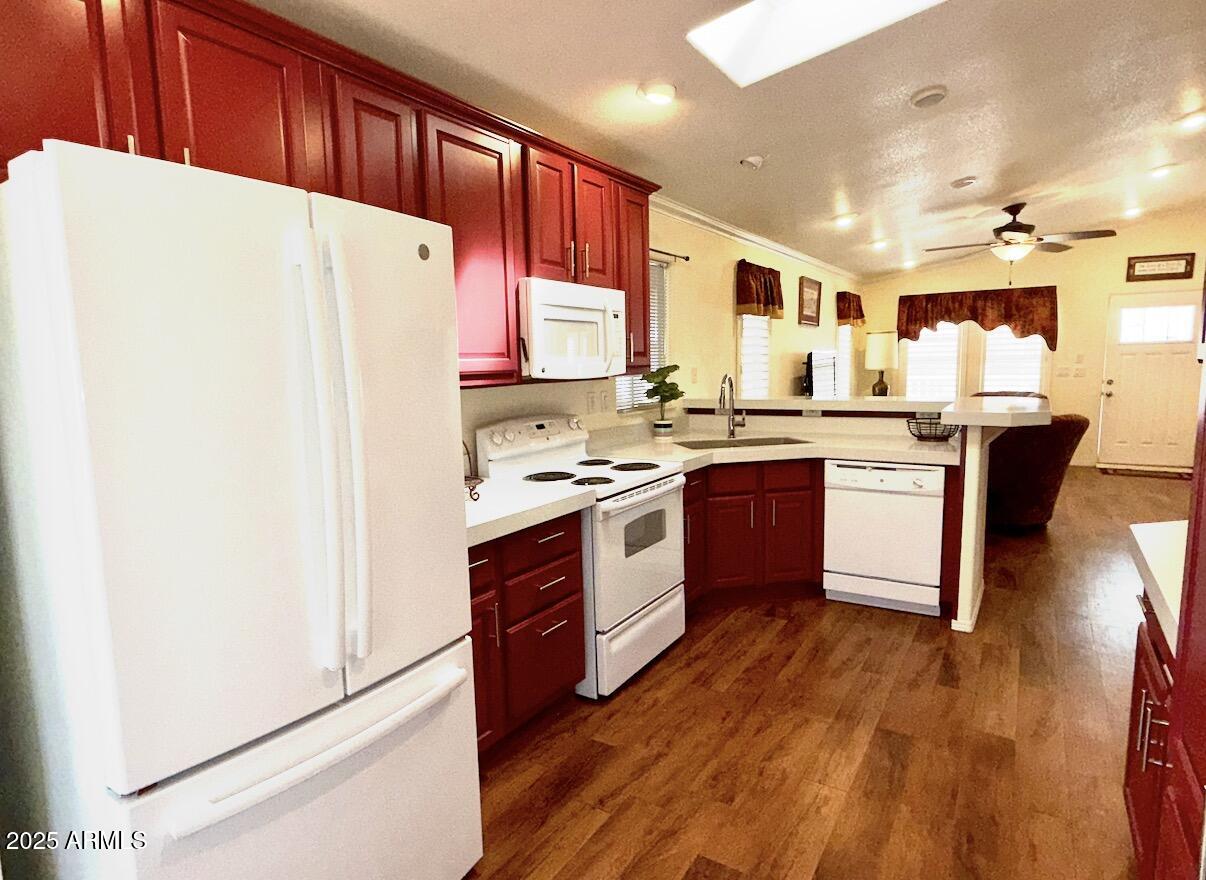 2929 East Main Street, Unit 219 Mesa, AZ 85213 - Photo 11 of 56 a kitchen with stainless steel appliances granite countertop a stove a sink a refrigerator and island with wooden floor