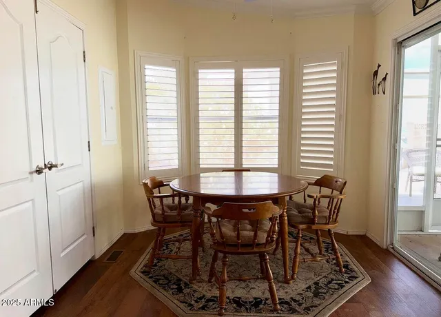 a kitchen with stainless steel appliances granite countertop a stove a sink a refrigerator and island with wooden floor