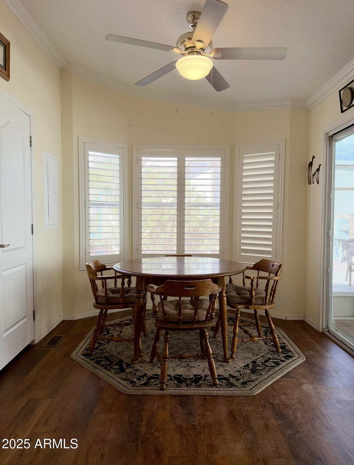2929 East Main Street, Unit 219 Mesa, AZ 85213 - Photo 13 of 56 a view of a dining room with furniture window and wooden floor