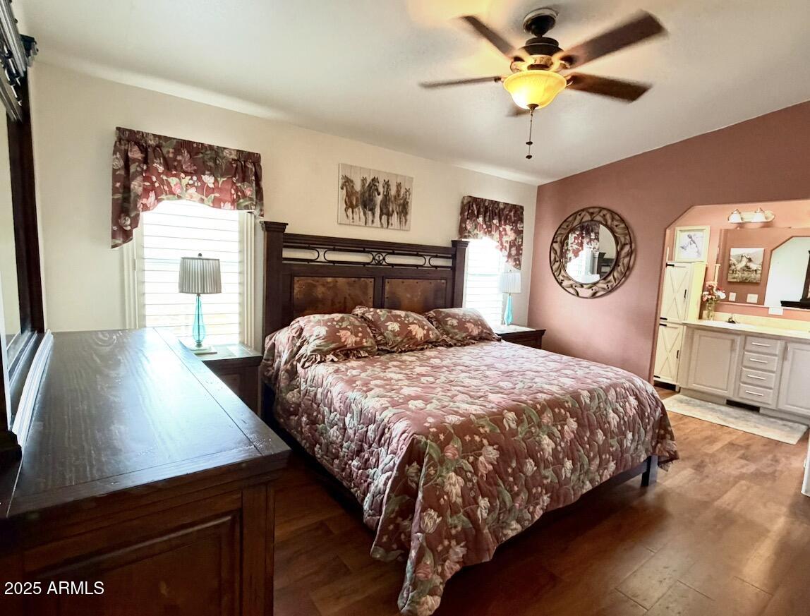 2929 East Main Street, Unit 219 Mesa, AZ 85213 - Photo 19 of 56 a bedroom with a large bed and a chandelier