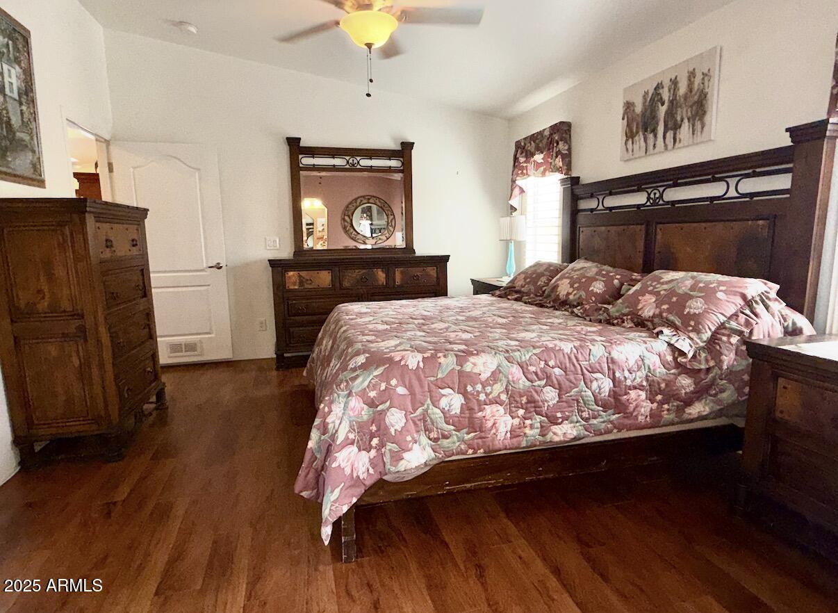 2929 East Main Street, Unit 219 Mesa, AZ 85213 - Photo 20 of 56 a bedroom with bed and wooden floor