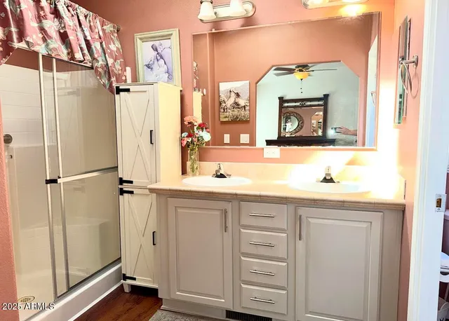 a bedroom with bed and wooden floor