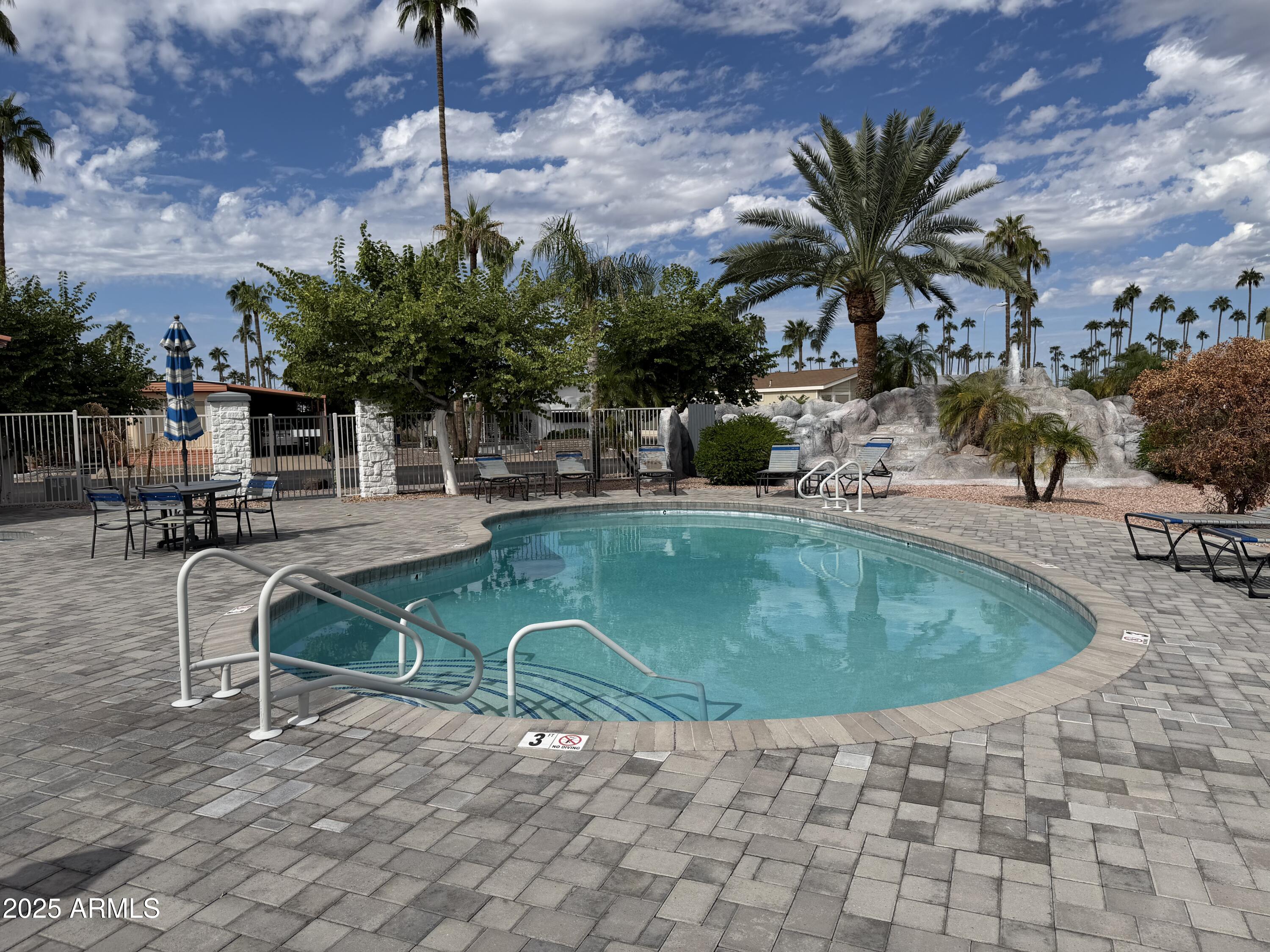 2929 East Main Street, Unit 219 Mesa, AZ 85213 - Photo 36 of 56 a swimming pool with outdoor seating yard and barbeque oven