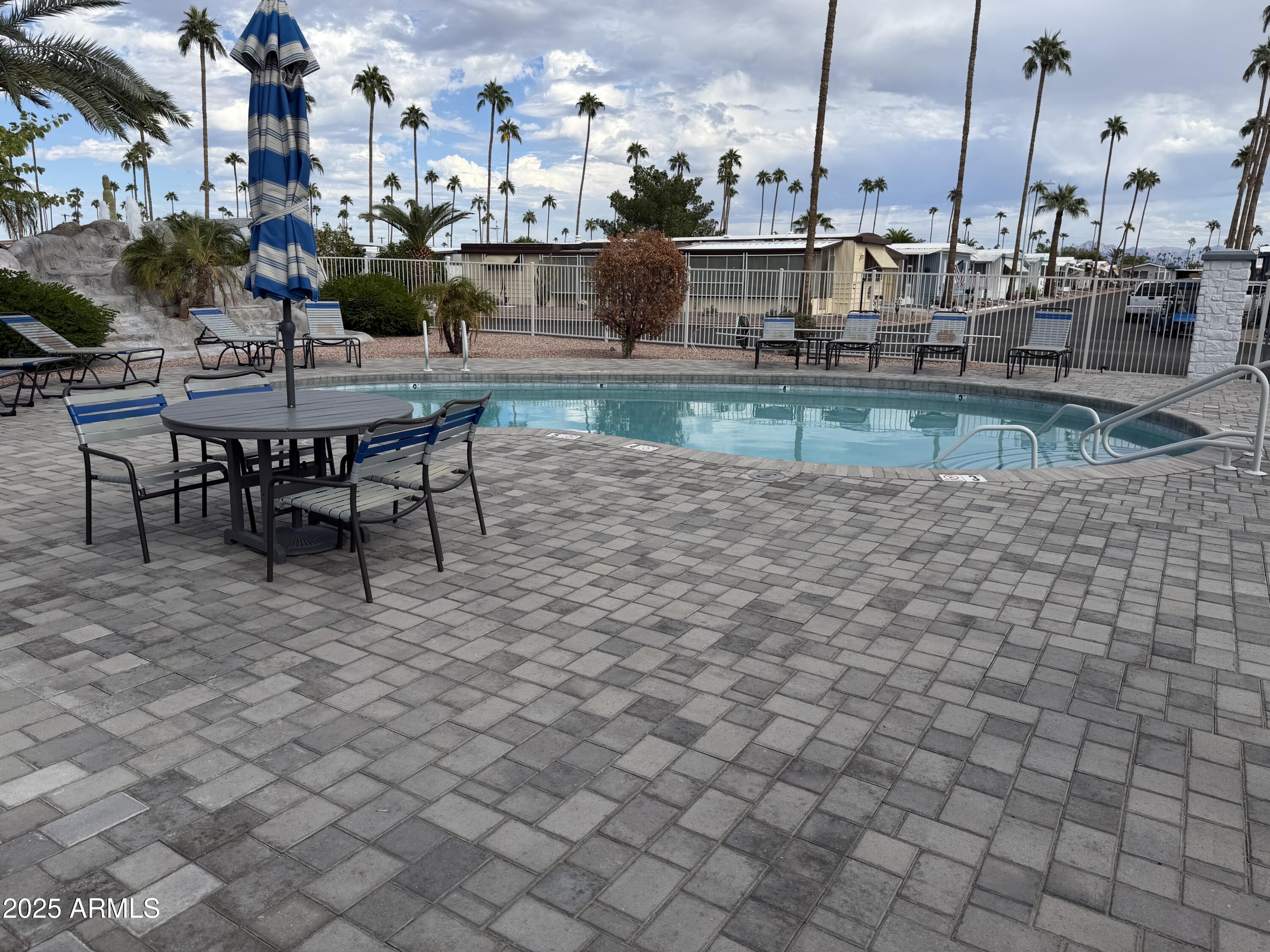 2929 East Main Street, Unit 219 Mesa, AZ 85213 - Photo 38 of 56 a view of a swimming pool with outdoor seating