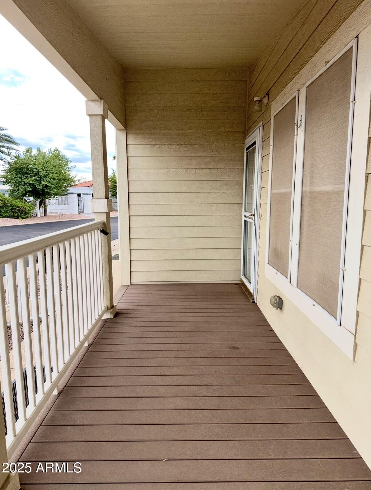 2929 East Main Street, Unit 219 Mesa, AZ 85213 - Photo 4 of 56 a view of a balcony with wooden floor