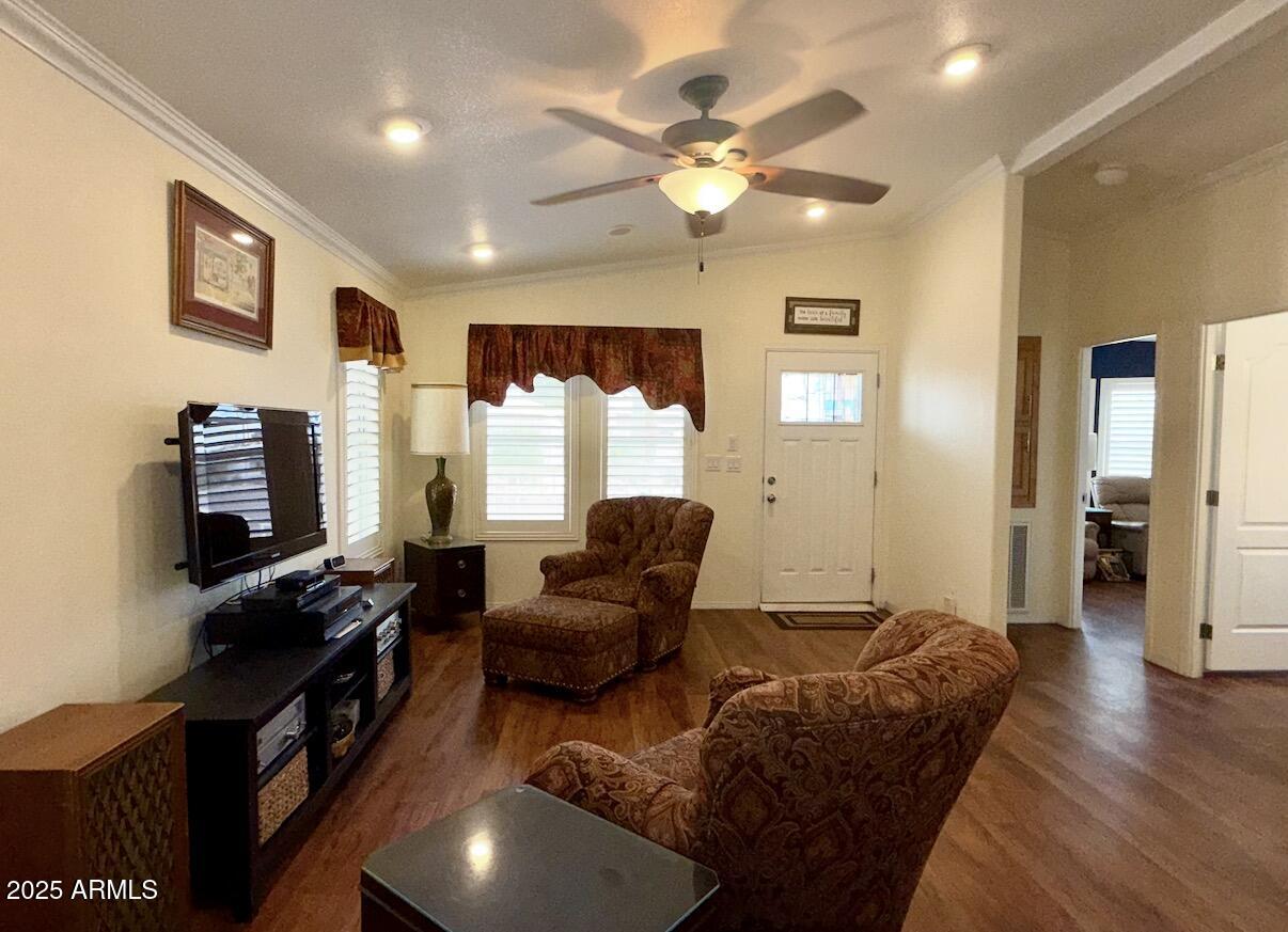 2929 East Main Street, Unit 219 Mesa, AZ 85213 - Photo 6 of 56 a living room with furniture a chandelier and a flat screen tv