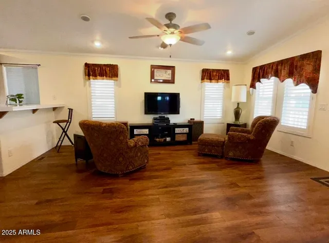 a living room with furniture a chandelier and a flat screen tv