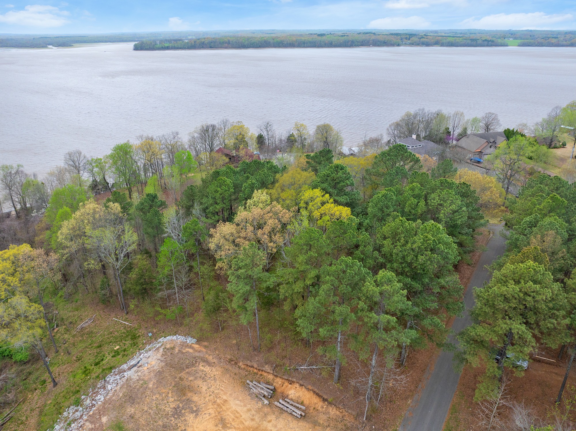 0 Branch Loop Big Sandy, TN 38221 - Photo 14 of 16 a view of a lake with a yard and mountain in the back